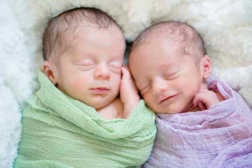 Bebês gêmeos abraçados